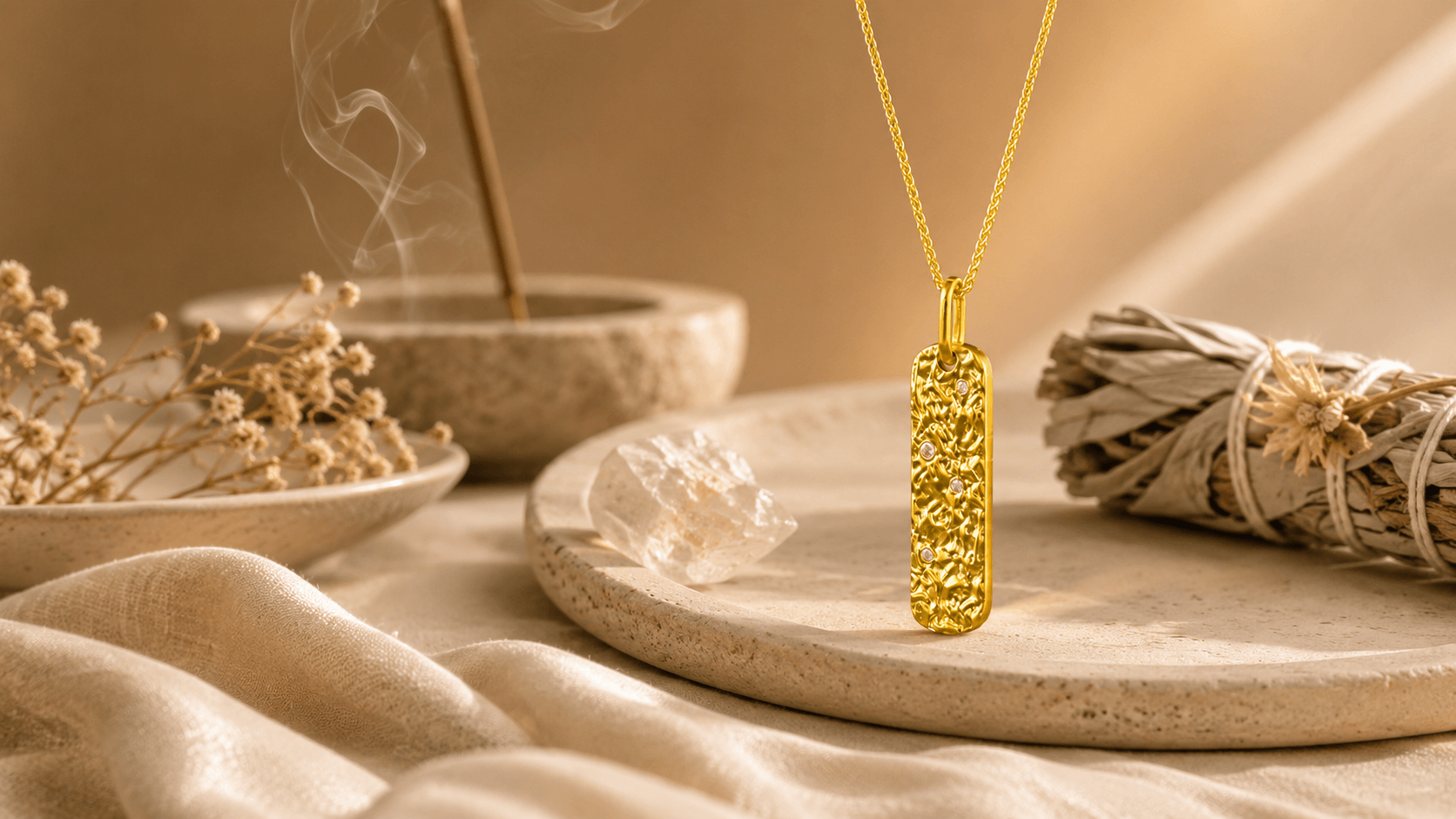 Metal Element gold pendant necklace prepared in a calm cleansing setting with incense and natural ritual objects