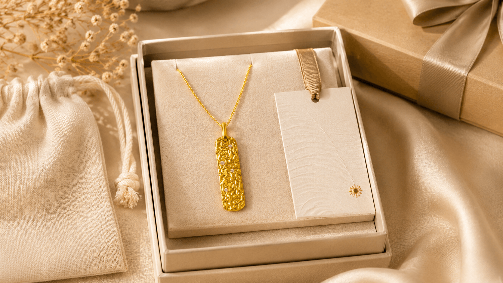 Metal Element gold pendant necklace arranged in a presentation box with storage pouch and card for delivery