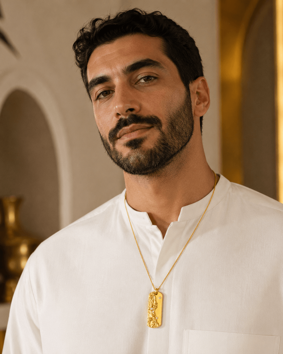 Middle Eastern man wearing the Metal Element Gold Pendant Necklace with a white traditional shirt