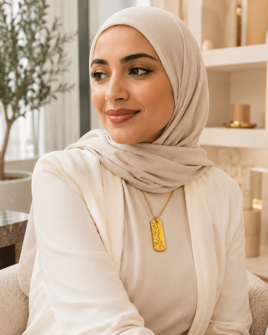 Middle Eastern woman in a beige hijab wearing the Metal Element Gold Pendant Necklace