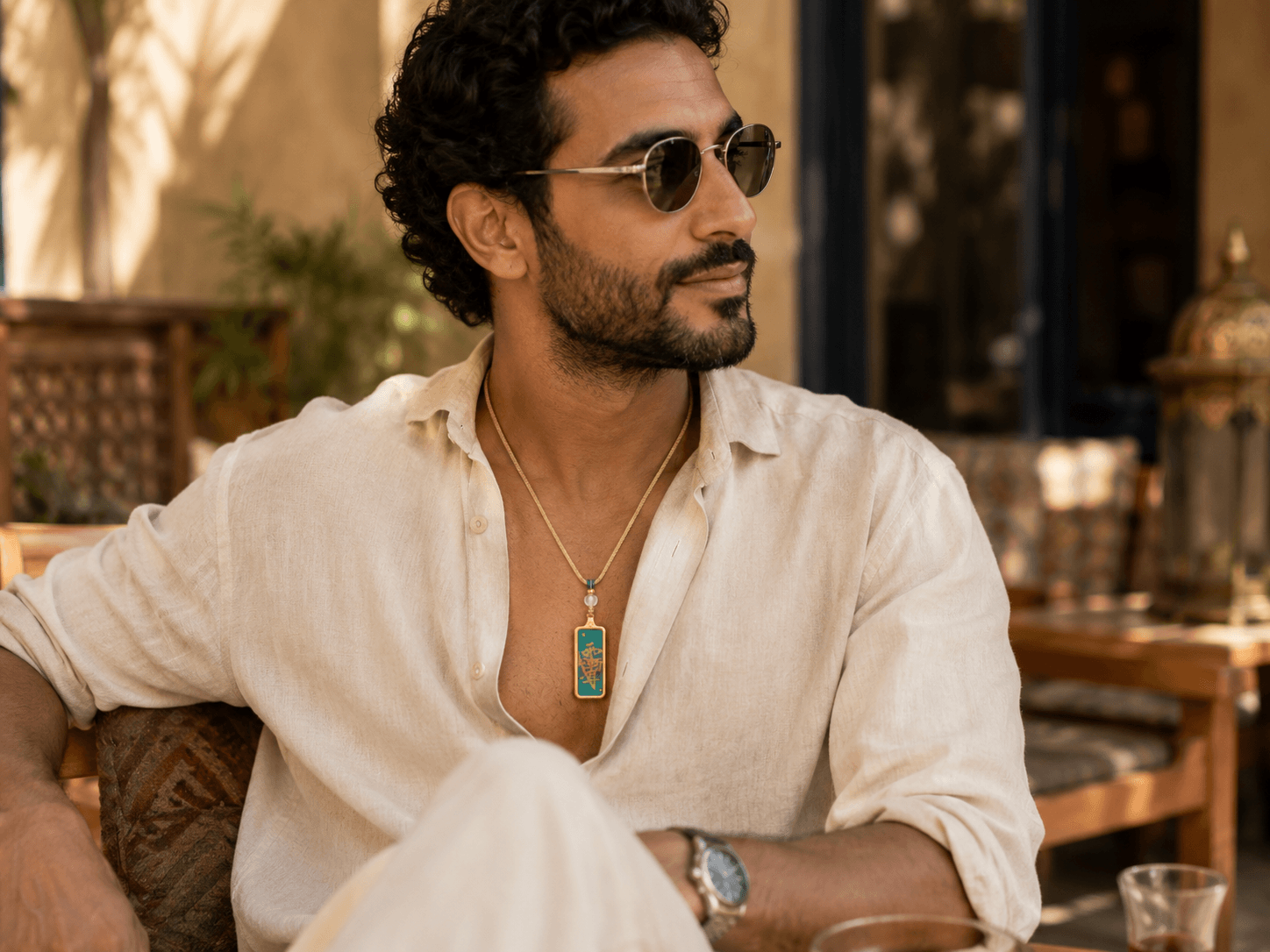 Man wearing the green Five Element guardian necklace in daily styling
